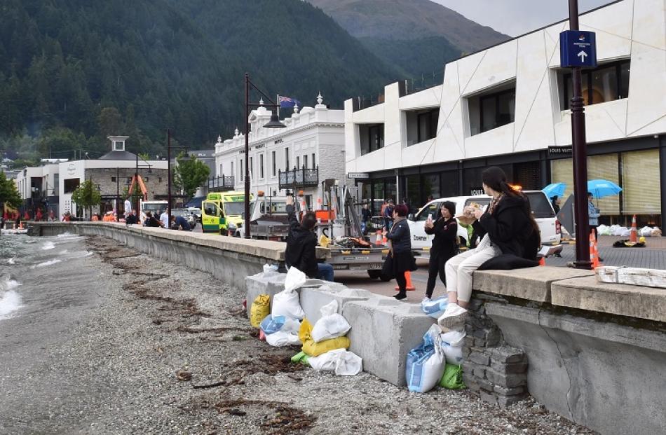 Tourists on a sandbagged wall in Queenstown. Photo: Gregor Richardson