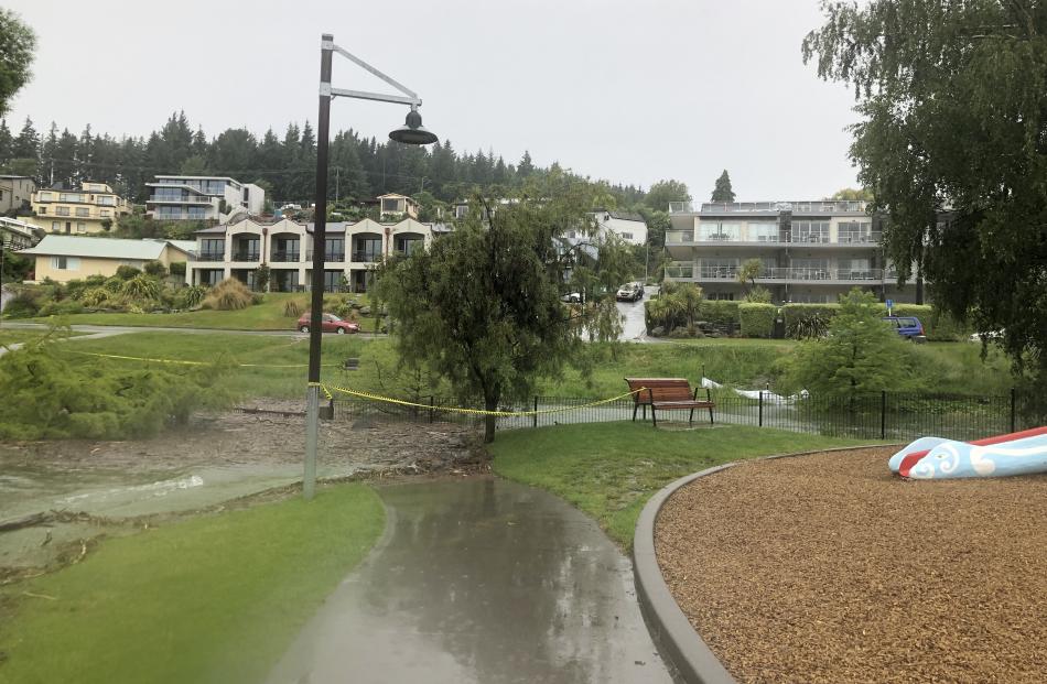 Overnight water had started to enter the Dinosaur Park playground and this morning contractors were out sandbagging the public toilets near the log cabin. Photo: Kerrie Waterworth