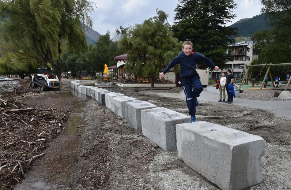 Leo Devlin (10), of Queenstown, plays on freshly laid concrete blocks in Queenstown Bay, part of...