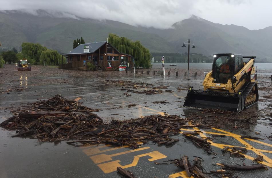 Debris is cleared from near the Log Cabin on Wanaka’s waterfront. 