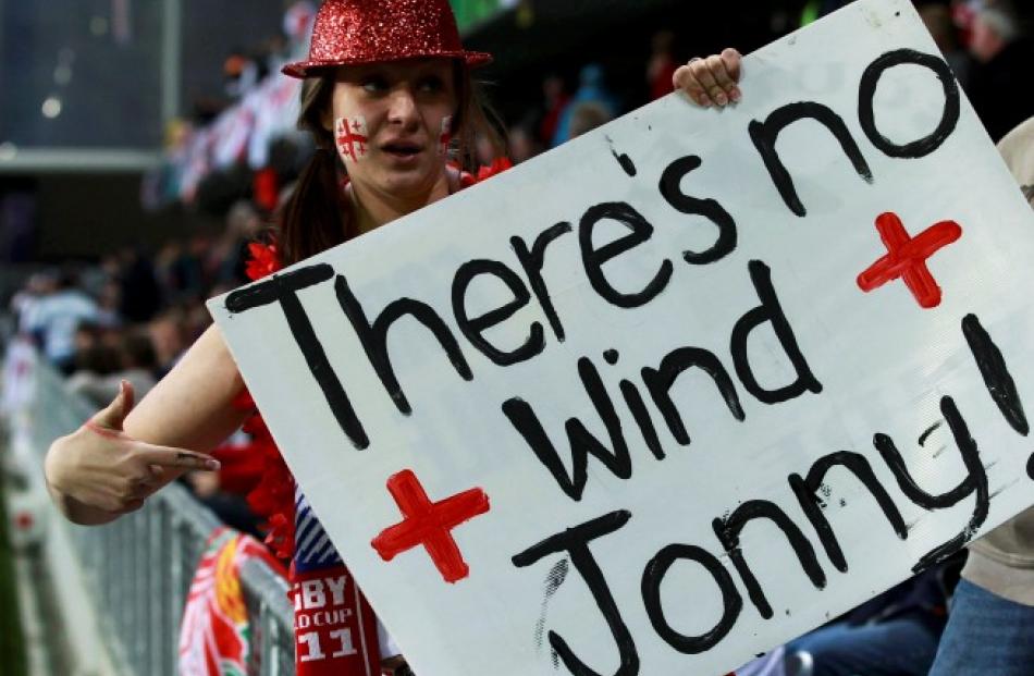 A Georgia supporter holds a sign relating to England first five Jonny Wilkinson. Photo: REUTERS...
