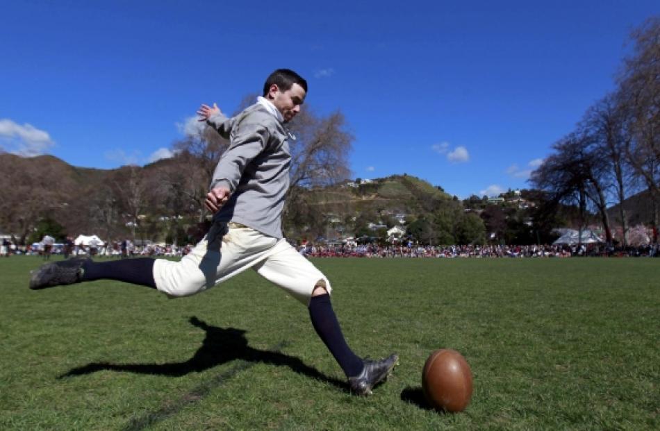 A player of Nelson Rugby Club, dressed in traditional rugby clothing, kicks the ball during the...