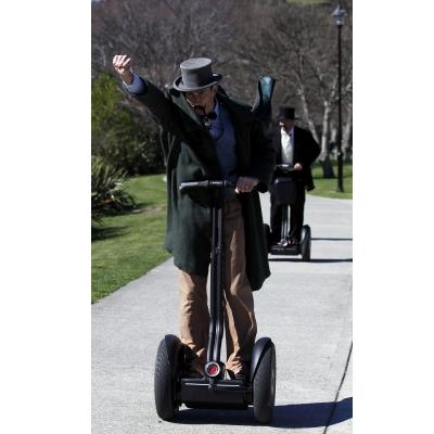 Men in traditional clothing ride on Segways after the re-enactment of the first match rugby ever...
