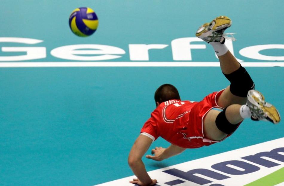 Bulgaria's Vladislav Ivanov dives for the ball during his side's European Volleyball Championship...
