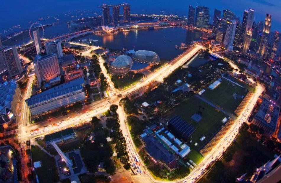 An aerial view shows part of the illuminated Marina Bay street circuit of the Singapore Grand...