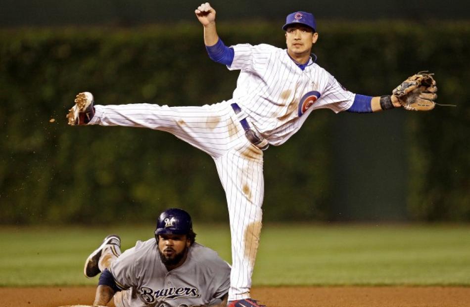 Milwaukee Brewers' Prince Fielder breaks up a double play attempt by Chicago Cubs' Darwin Barney...