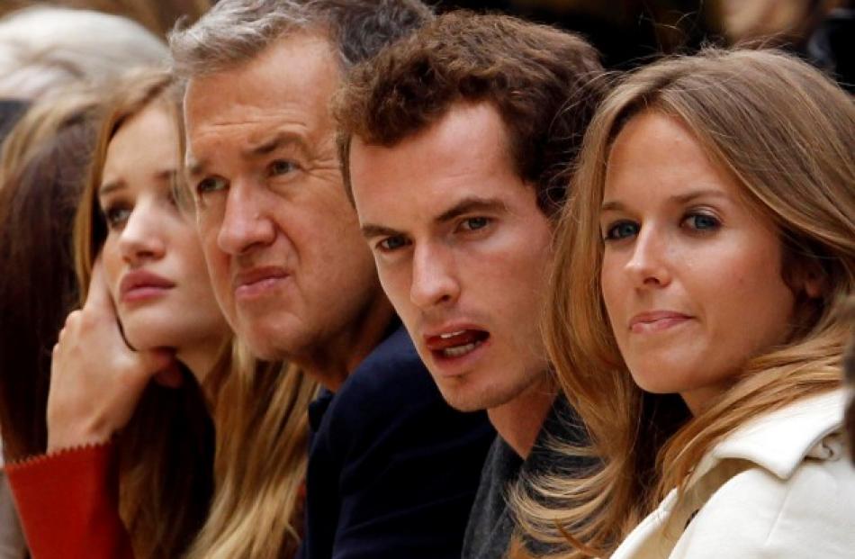 Watching a presentation during London Fashion Week are (from left) actress Rosie Huntington...