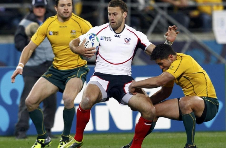 Australia Wallabies' Anthony Fainga'a (right) tackles Kevin Swiryn (centre) of the US as Adam...