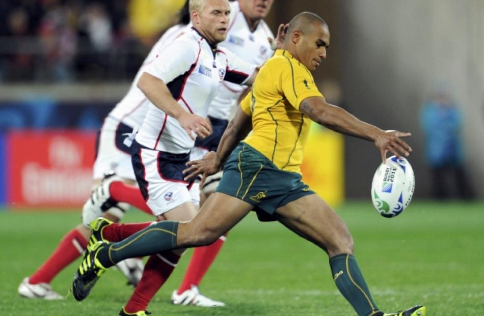 Australia Wallabies captain Will Genia kicks the ball during their Rugby World Cup Pool C match...