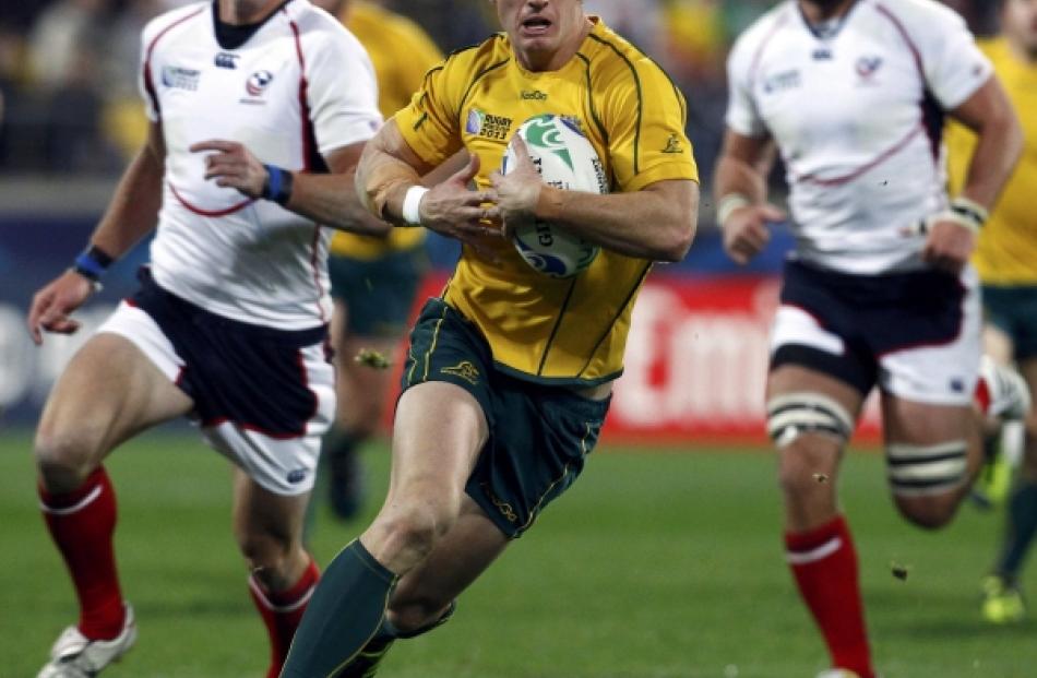 Australia Wallabies' Rob Horne runs with the ball during their Rugby World Cup Pool C match...