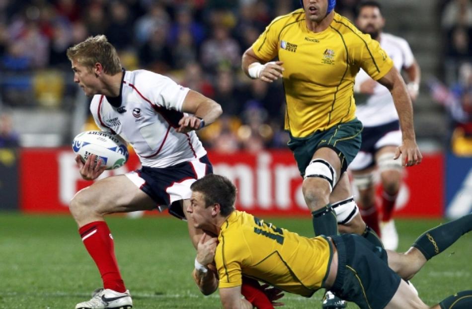 Australia Wallabies' Rob Horne tackles Colin Hawley (left) of the US during their Rugby World Cup...