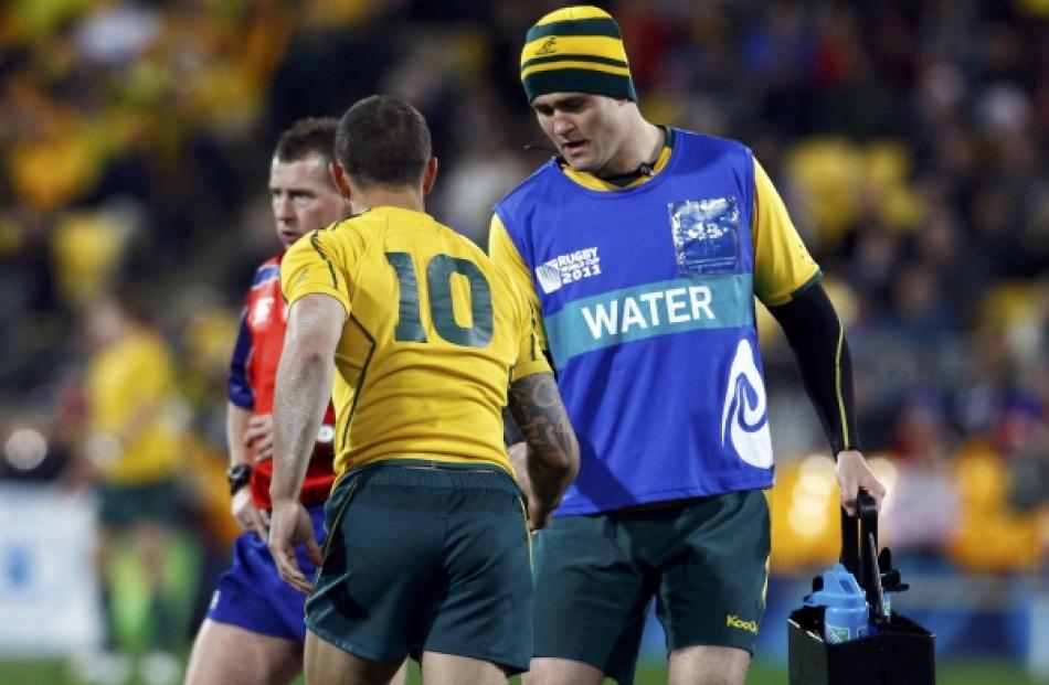 Australia Wallabies World Cup team captain James Horwill (right) brings water to teammate Quade...