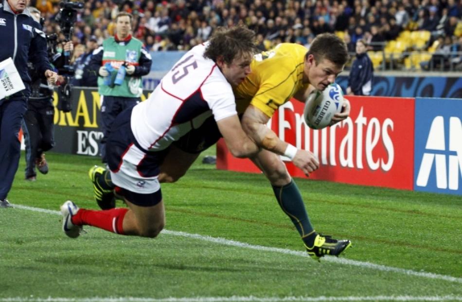 Blaine Scully of the US fails to prevent Australia Wallabies' Rob Horne (right) from scoring...
