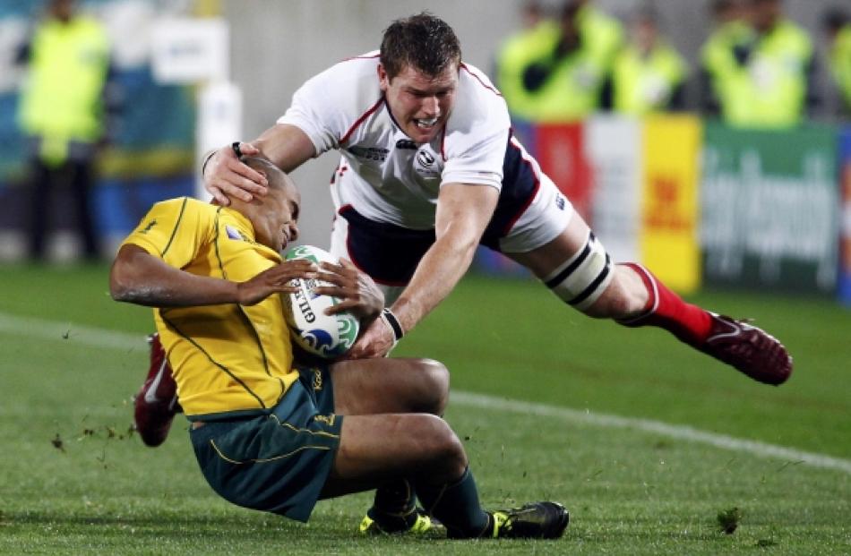 Hayden Smith (right) of the US tackles Australia Wallabies captain Will Genia during their Rugby...
