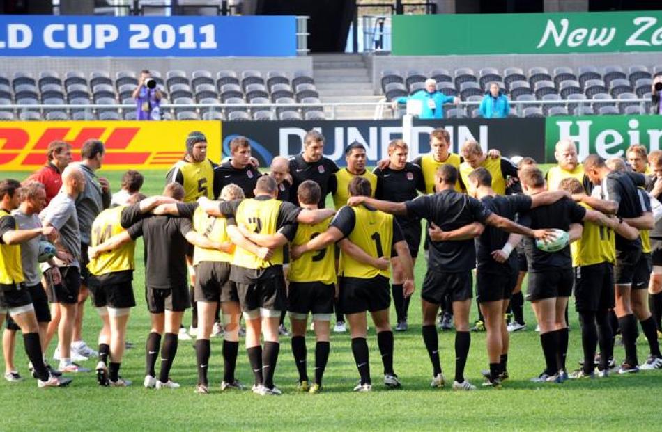 The England rugby team stands united at training at Otago Stadium yesterday. Photo by Stephen...