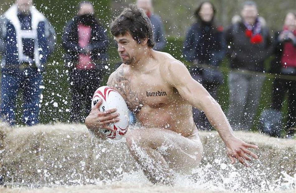 A naked rugby player takes a shortcut through the fountain at Larnach Castl...