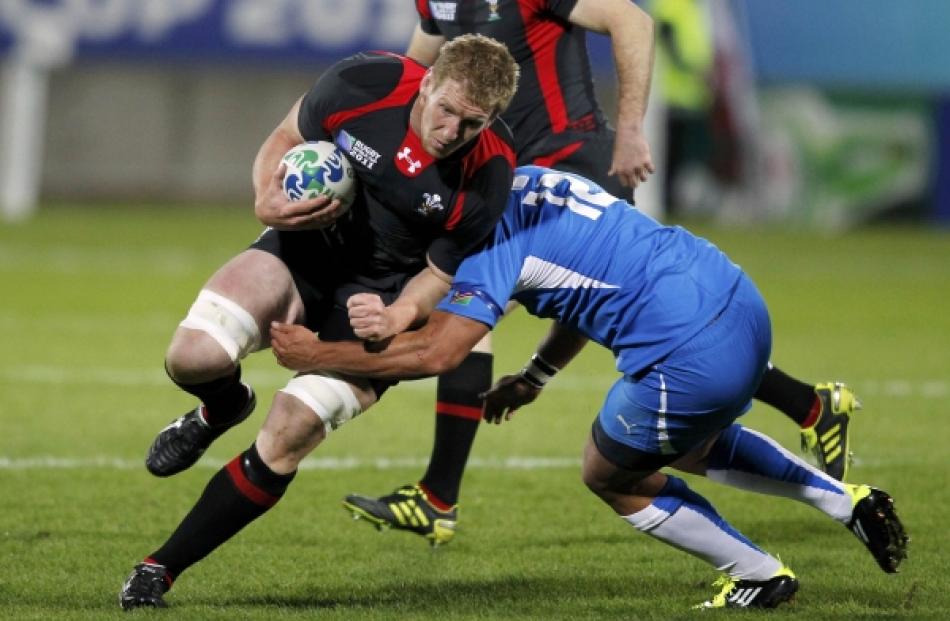 Namibia's Darryl De La Harpe (right) tackles Wales' Bradley Davies during their Rugby World Cup...