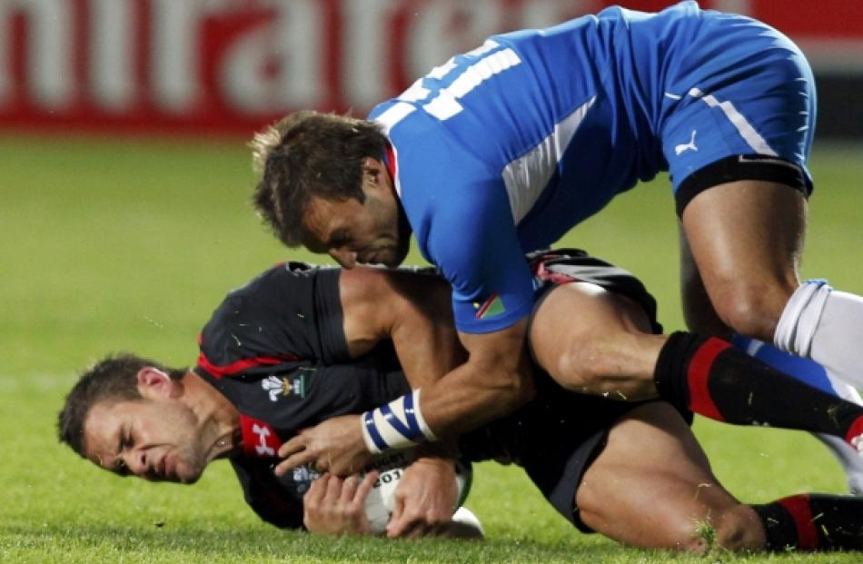 Namibia's Piet Van Zyl (right) tackles Wales' Lee Byrne during their Rugby World Cup Pool D match...