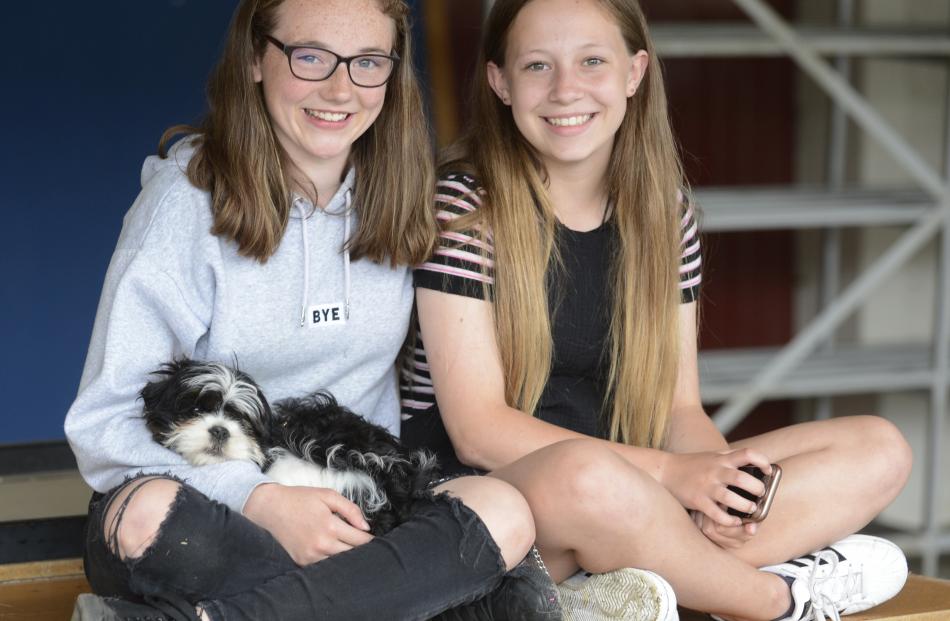 Stephanie Clydesdale (left) and Mila Stace (both 13) enjoy the races with dog Mickey.