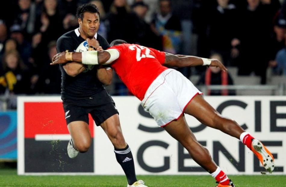 Tonga's Alipate Fatafehi (right) on Isaia Toeava, of the All Blacks.