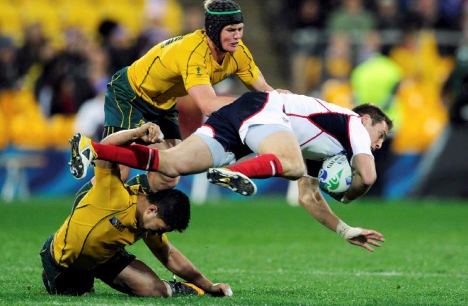 Wallabies Berrick Barnes (top) and Anthony Fainga'a combine to tackle Chris Wyles of the US.