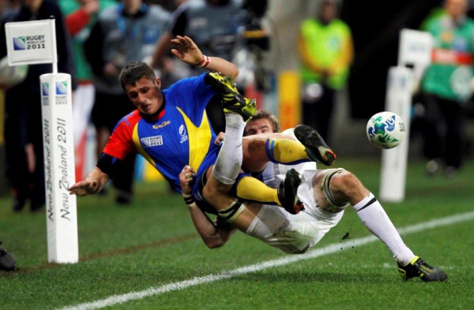 England's Tom Croft brings Romania's Adrian Marian Apostol down.