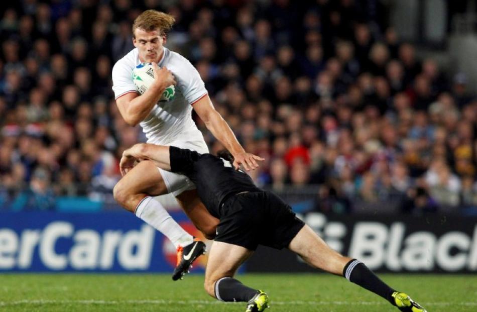 Conrad Smith of the All Blacks tackles France's Aurelien Rougerie.