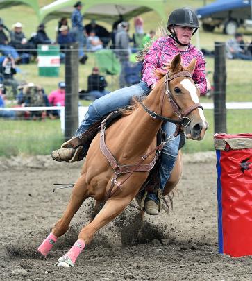 Rubie Cummings, of Lawrence, rounds the bend in the second division barrel race.