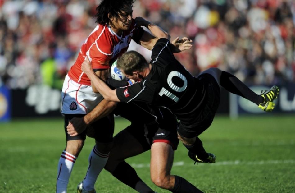 Canada's Ander Monro (10) attempts to tackle Japan's Kosuke Endo (left) during their Rugby World...