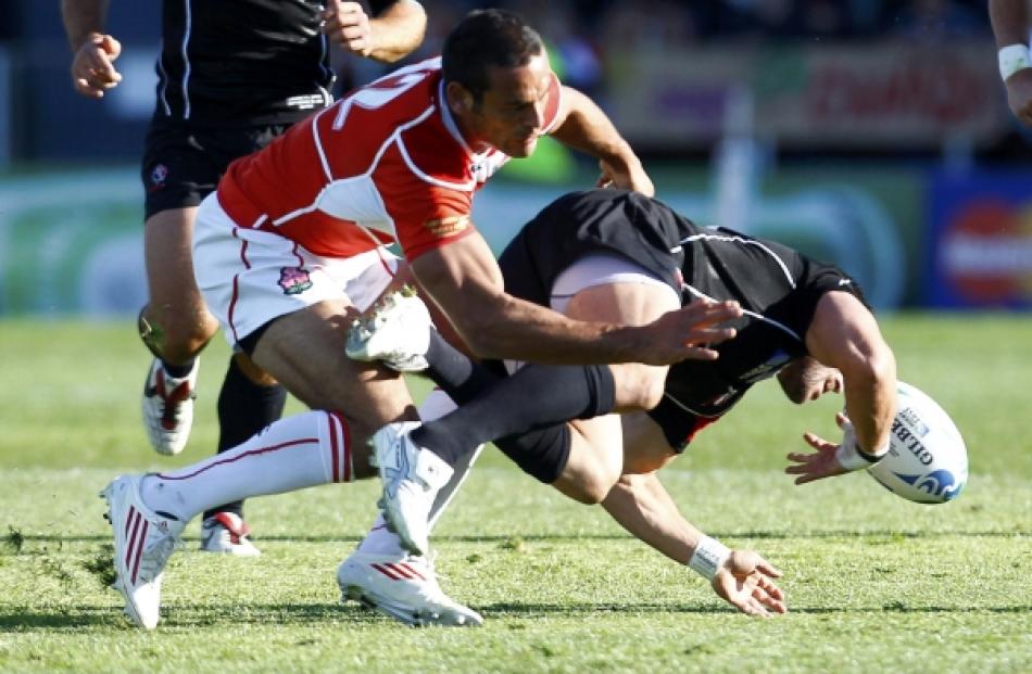 Canada's James Pritchard (R) collides with Japan's Ryan Nicholas and injures himself during their...