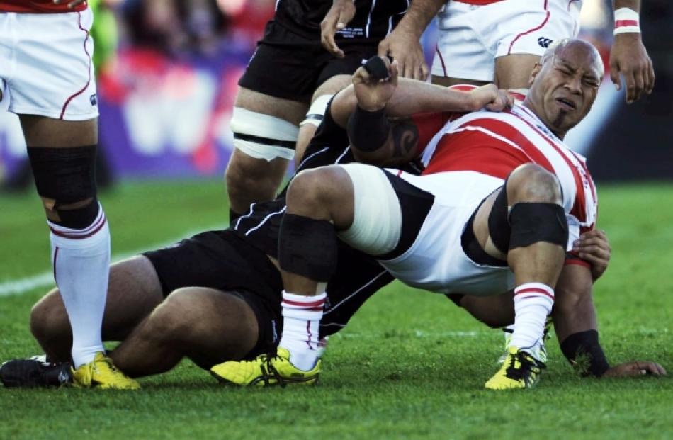 Canada's Jason Marshall tackle Japan's Alisi Tupuailai (right) during their Rugby World Cup Pool...