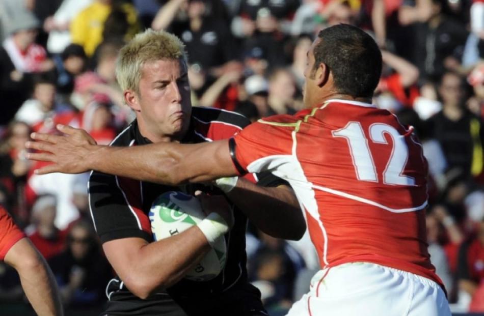Japan's Ryan Nicholas (right) tackles Canada's DTH van der Merwe during their Rugby World Cup...