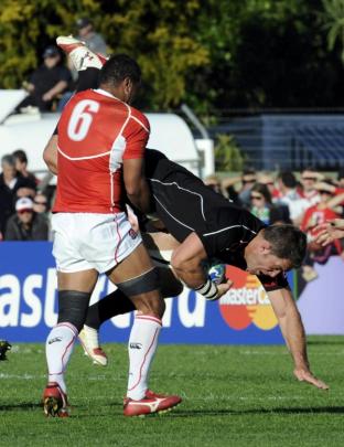 Japan's Sione Talikavili Vatuvei (left) tackles Canada's Jamie Cudmore during their Rugby World...