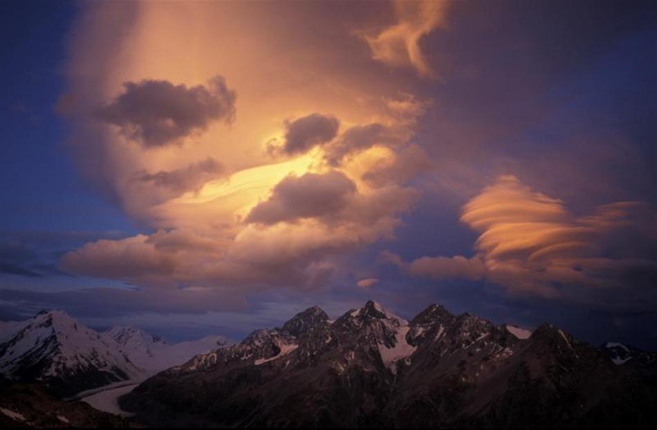 Fire ball: Late evening storm clouds assemble over the Malte Brun range and the Tasman Valley in...