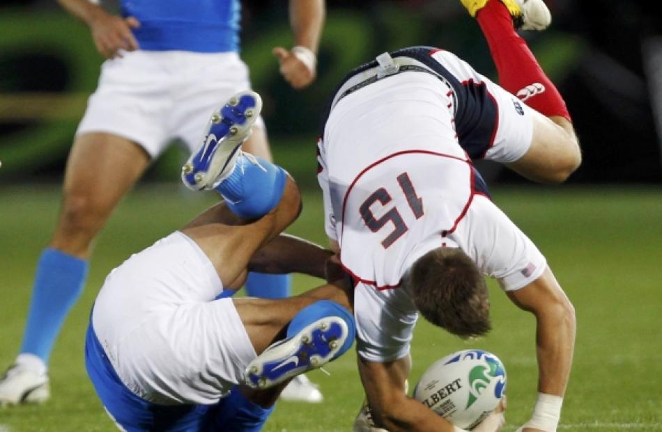 Italy's Gonzalo Canale (left) tackles Chris Wyles of the US during their Rugby World Cup Pool C...