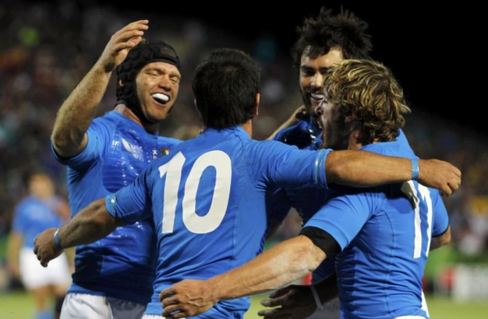 Italy's Luciano Orquera (10) celebrates scoring a try with teammates during their Rugby World Cup...