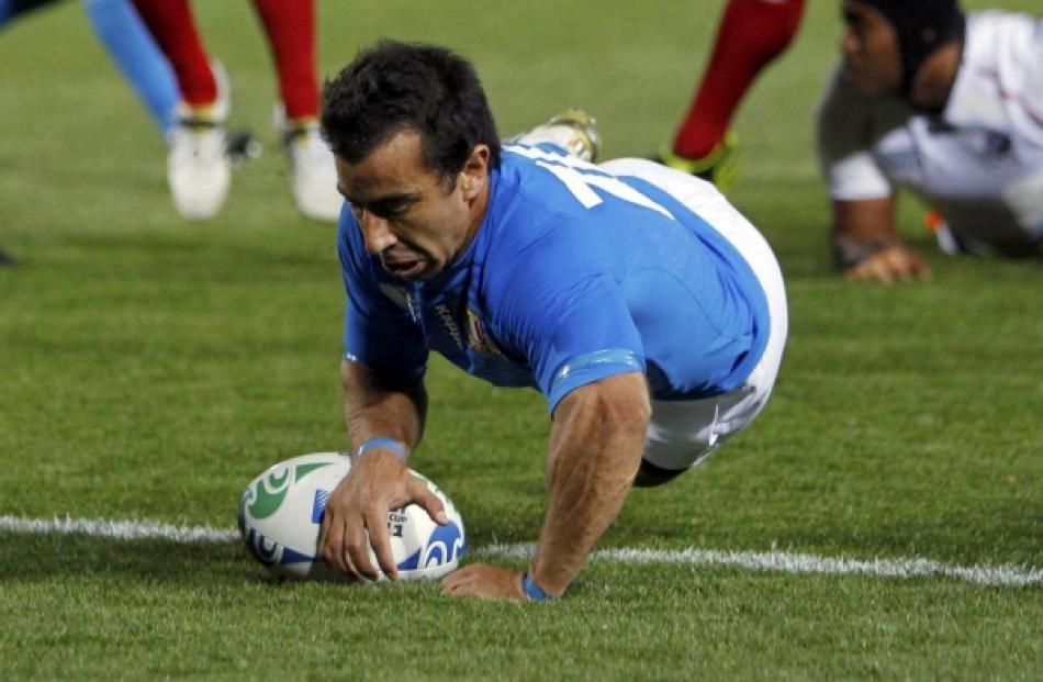 Italy's Luciano Orquera scores a try during their Rugby World Cup Pool C match against the US at...