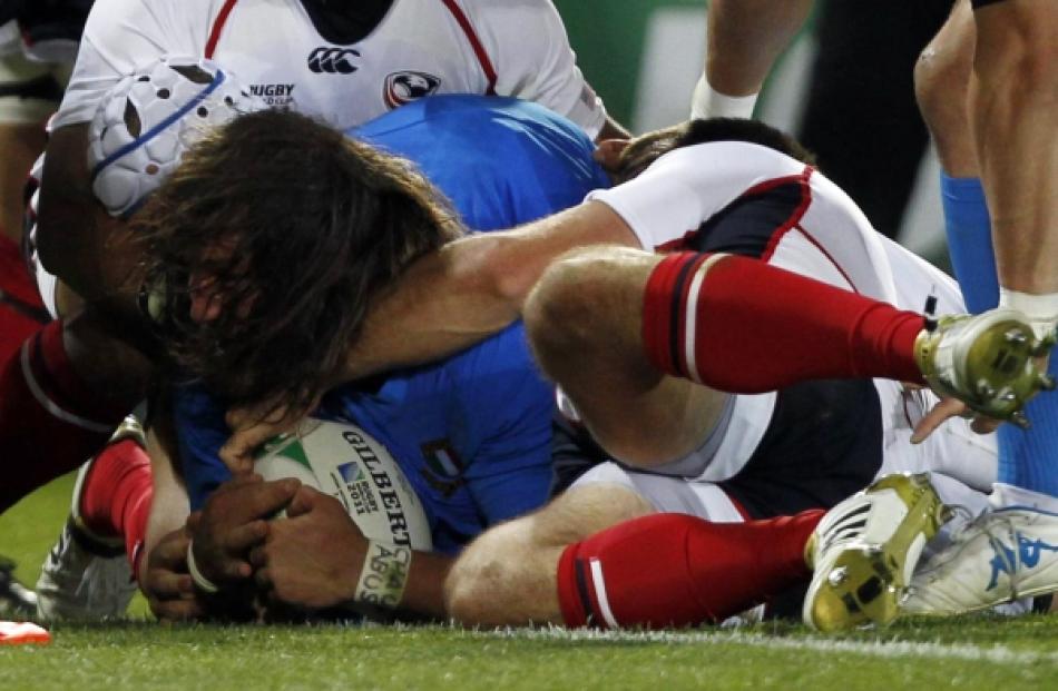 Italy's Martin Castrogiovanni scores a try during their Rugby World Cup Pool C match against the...