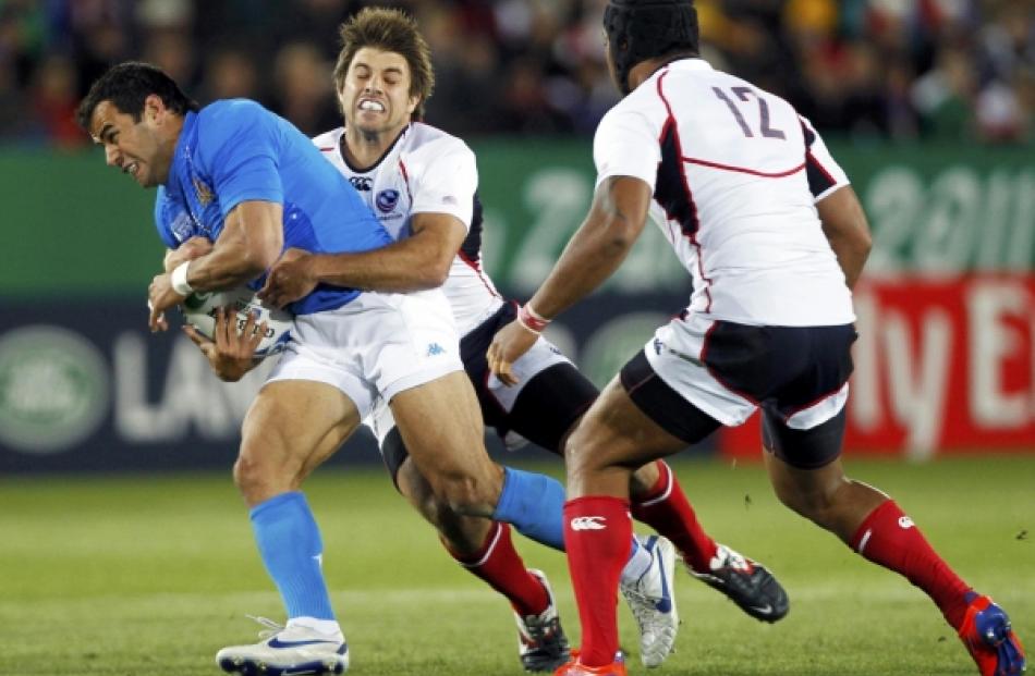 James Paterson (centre) of the US tackles Italy's Gonzalo Canale (left) during their Rugby World...
