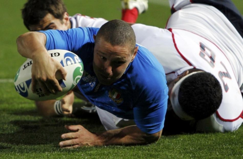 Matekitonga Moeakiola (right) of the US tackles Italy's Fabio Semenzato during their Rugby World...