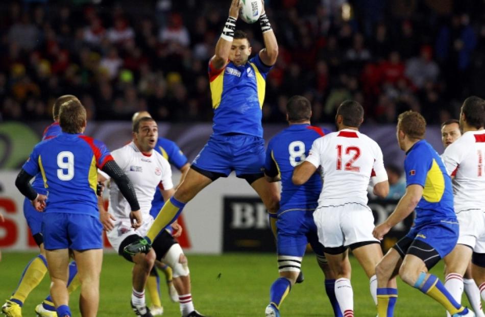 Romania's Madalin Vlad Lemnaru takes a high ball during their Rugby World Cup Pool B match...