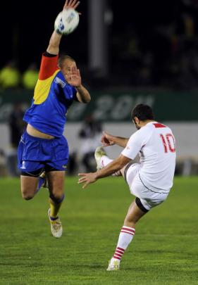 Romania's Marin Danut Dumbrava (left) attempts to block a kick from Georgia's Merab Kvirikashvili...