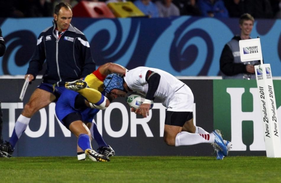 Romania's Stefan Eugen Ciuntu (left) tackles Georgia's Alexander Todua during their Rugby World...