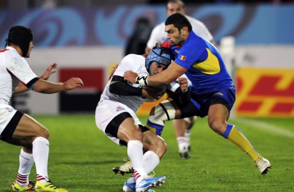 Romania's Stefan Eugen Ciuntu (right) tackles Georgia's Alexander Todua during their Rugby World...