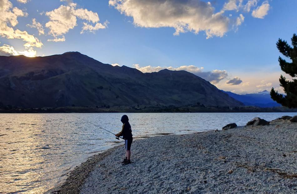 William Evans (10), of Mosgiel, enjoys an evening’s fishing in Lake Wanaka. Photo: Katie Evans