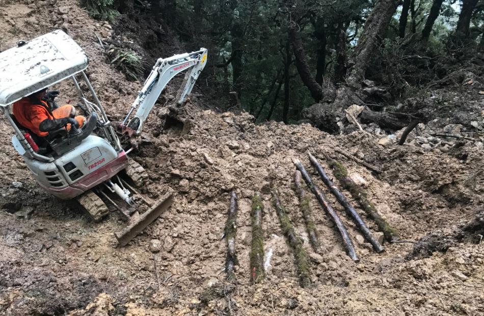 Crews had to lay logs across deep mud to stop machinery sinking. PHOTO: JIM MCILRAITH
