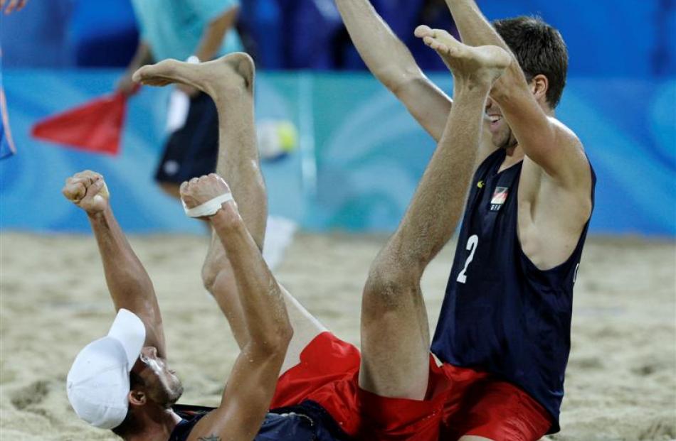 Germany's Eric Koreng, left, and David Klemperer react after defeating the Netherlands in a beach...