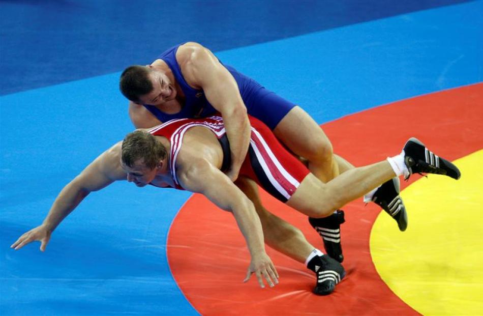 Armenia's Yuri Patrikeev, red, wrestles Sweden's Jalmar Sjoberg during the bronze medal bout of...