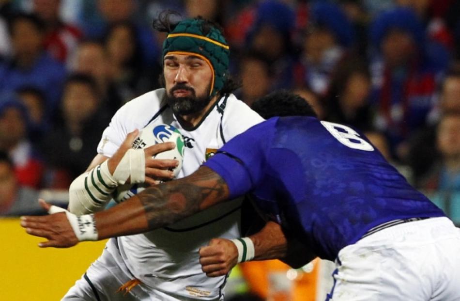 Samoa's George Stowers tackles South Africa Springboks captain Victor Matfield (left) during...