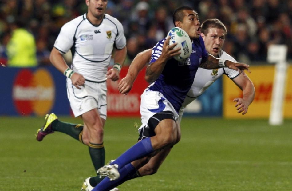 Samoa's Kahn Fotuali'i runs with the ball during their Rugby World Cup Pool D match against South...